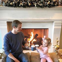 Family enjoys hot cocoa by the fire