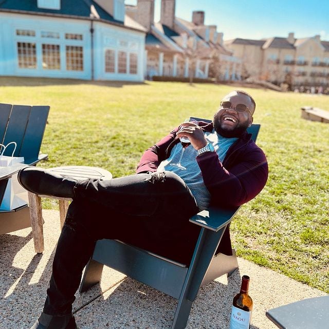 a man smiling and enjoying wine